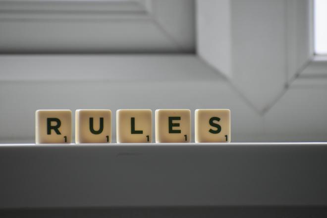 Similar cubes with RULES inscription on windowsill in building